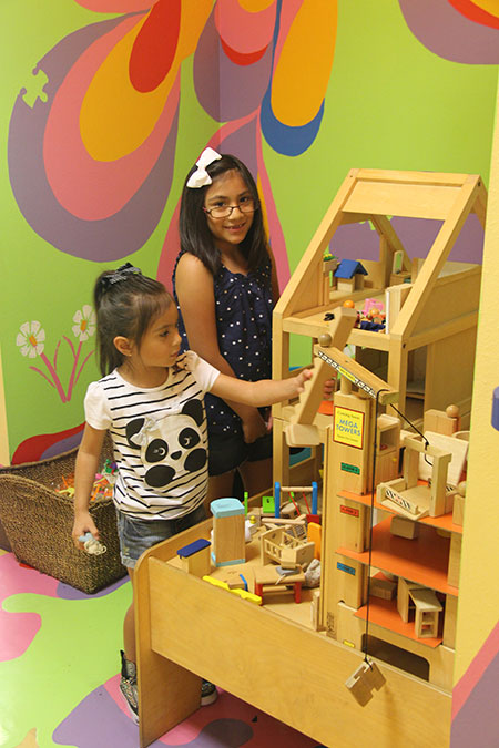 Kids playing with doll house - Pediatric Dentist in Newbury Park, CA